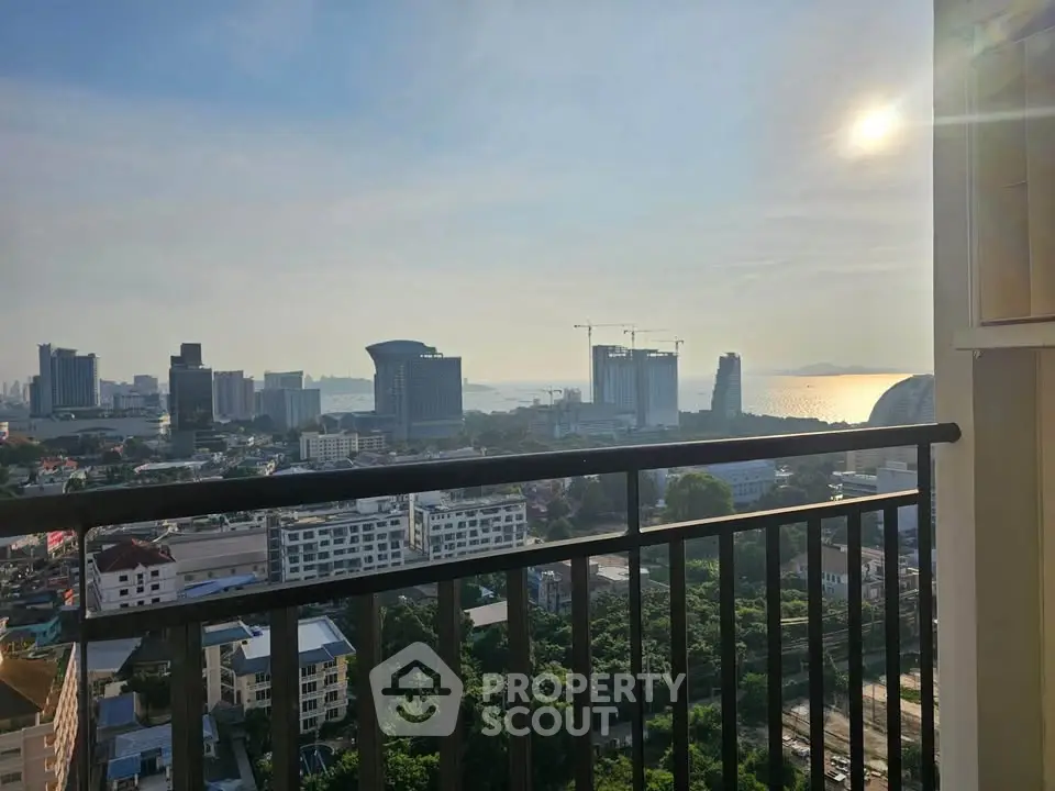 Stunning cityscape view from a high-rise balcony overlooking the skyline and ocean.