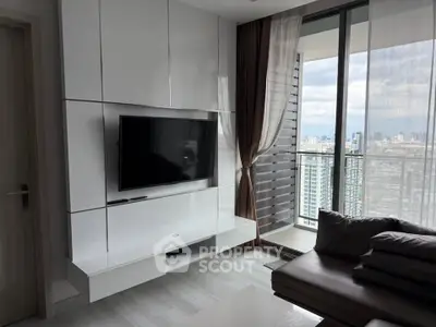 Modern living room with sleek TV unit and city view balcony