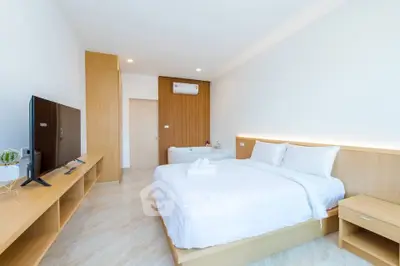 Spacious modern bedroom with elegant decor and natural light