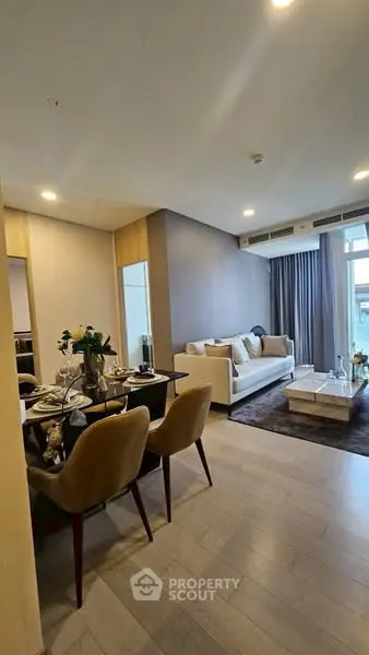 Modern living room with elegant dining area and cozy seating, perfect for stylish urban living.