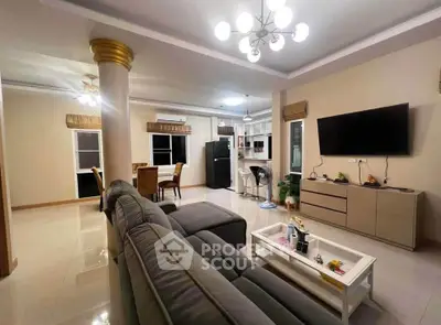 Spacious modern living room with elegant decor and open layout, featuring a cozy sofa and stylish lighting.