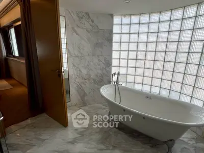 Luxurious bathroom with elegant freestanding bathtub and marble flooring