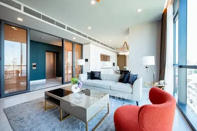 Luxurious modern living room with floor-to-ceiling windows and stylish furniture.