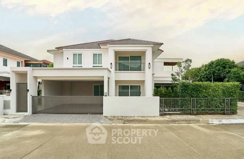 Modern two-story house with a spacious driveway and lush greenery, perfect for family living.