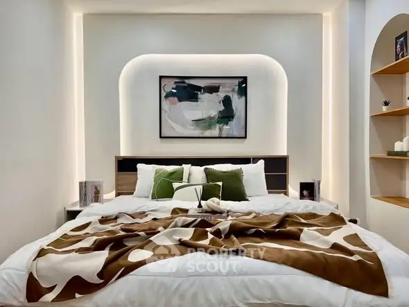 Luxurious bedroom with modern art and ambient lighting, featuring a stylish bed and elegant decor.