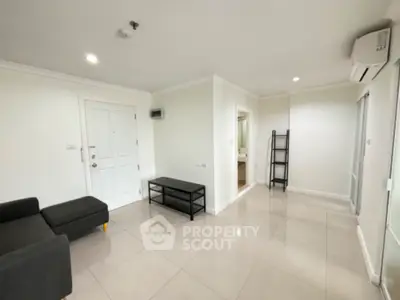 Spacious modern living room with sleek tiled flooring and minimalist furniture