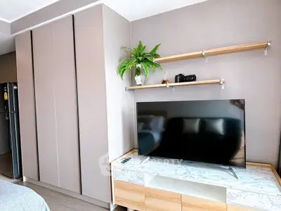 Modern living room with sleek TV setup and stylish shelving, perfect for contemporary urban living.