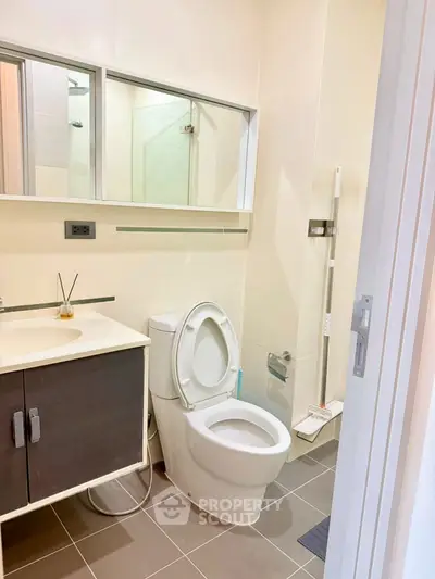 Modern bathroom with sleek fixtures and ample storage in a contemporary apartment.