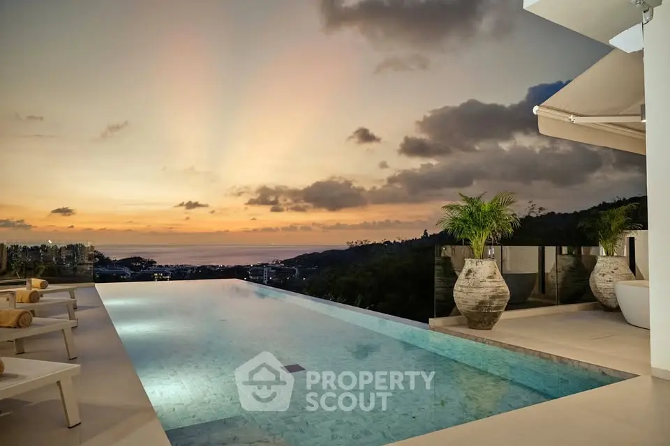 Luxurious infinity pool with stunning sunset view in a high-end property.