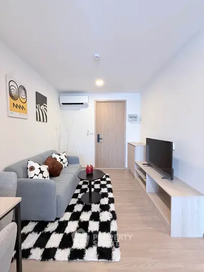 Modern living room with stylish decor and cozy seating area in a contemporary apartment.