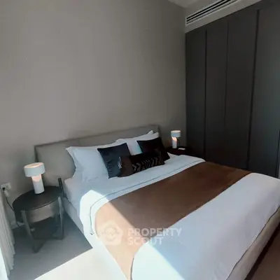 Cozy bedroom with modern decor and soft lighting, perfect for relaxation and comfort.
