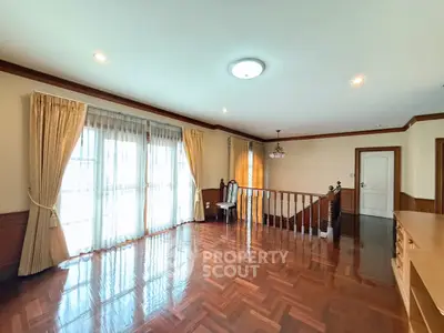 Spacious living room with elegant wooden flooring and large windows