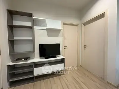 Modern living room with sleek TV unit and wooden flooring