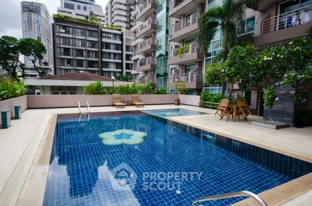 Luxurious condominium pool area with modern design and lush greenery