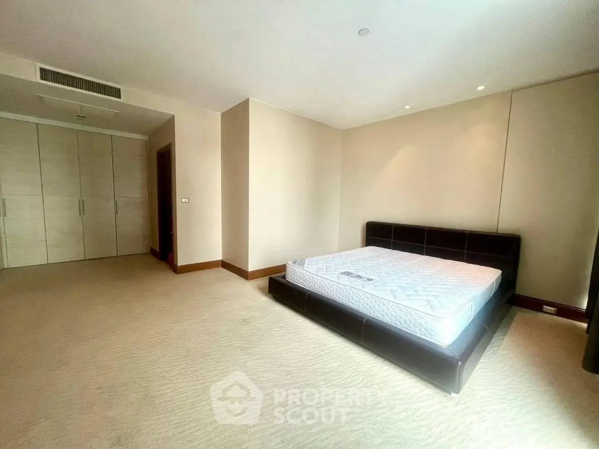 Spacious bedroom with modern design and ample natural light