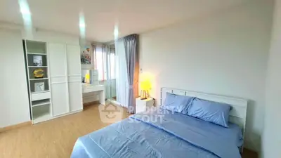 Spacious bedroom with modern decor and ample natural light