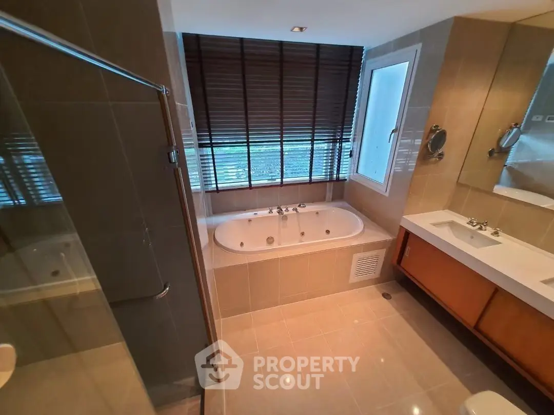Luxurious bathroom with modern fixtures and large bathtub in elegant apartment.