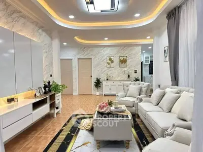 Luxurious living room with elegant decor and modern lighting, featuring plush seating and stylish accents.