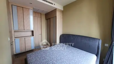 Modern bedroom with stylish wooden wardrobe and cozy bed in a contemporary apartment.