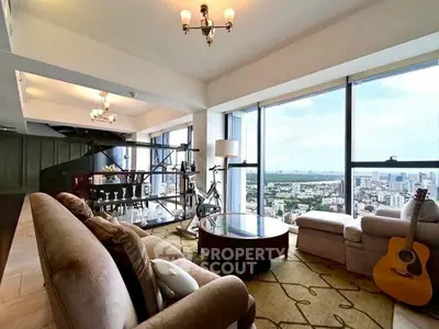 Spacious living room with panoramic city view and elegant furnishings.
