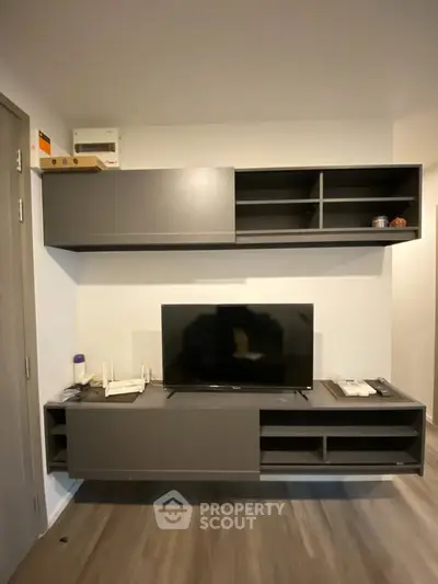Modern living room with sleek TV unit and stylish shelving