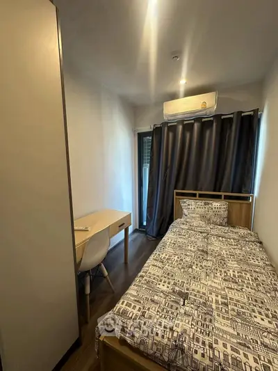 Cozy bedroom with modern decor and natural light, perfect for relaxation.