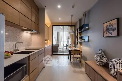 Modern kitchen with sleek wooden cabinets and open layout leading to dining area.