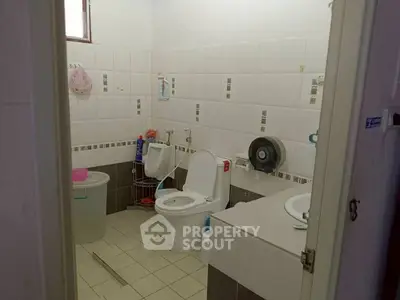 Functional bathroom with modern fixtures and tiled walls
