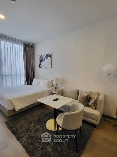 Modern bedroom with cozy seating area and elegant decor