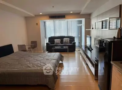 Modern studio apartment with cozy living area and sleek furnishings.