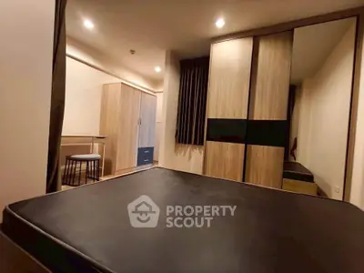 Modern bedroom with sleek furniture and ample storage space