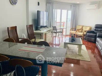 Spacious living room with modern furniture and large windows offering natural light.