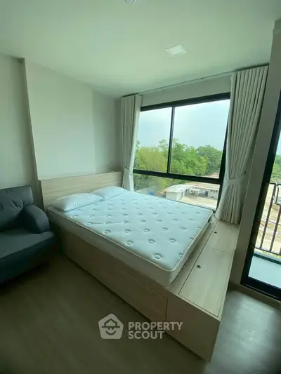 Modern bedroom with large window and scenic view, featuring a cozy bed and stylish decor.