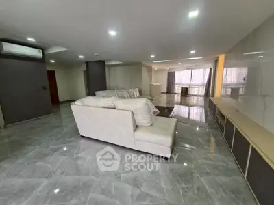 Spacious modern living room with elegant marble flooring and stylish furniture