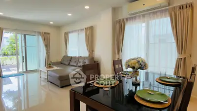 Spacious living room with elegant dining area and natural light