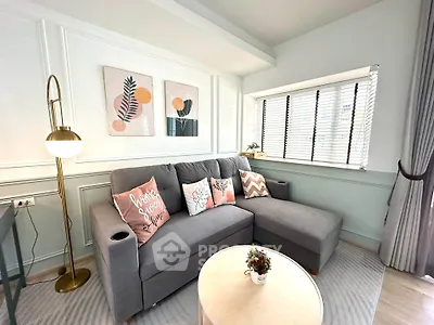 Chic and cozy living room with stylish decor and ample natural light.
