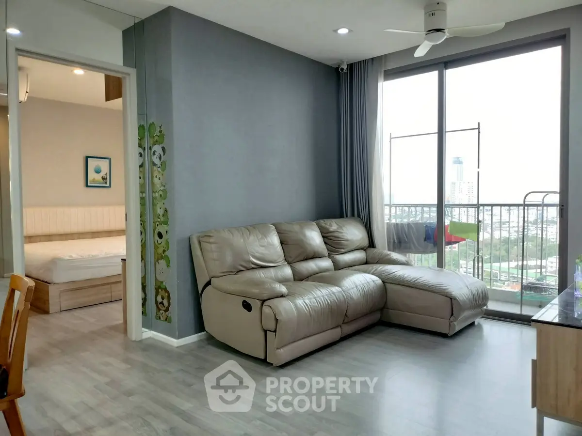Modern living room with leather sofa and balcony view in a stylish apartment.