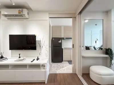 Modern living room with sleek TV setup and open kitchen view