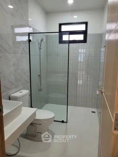 Modern bathroom with glass shower and sleek fixtures