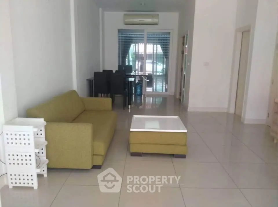 Spacious living room with modern furniture and large windows for natural light.