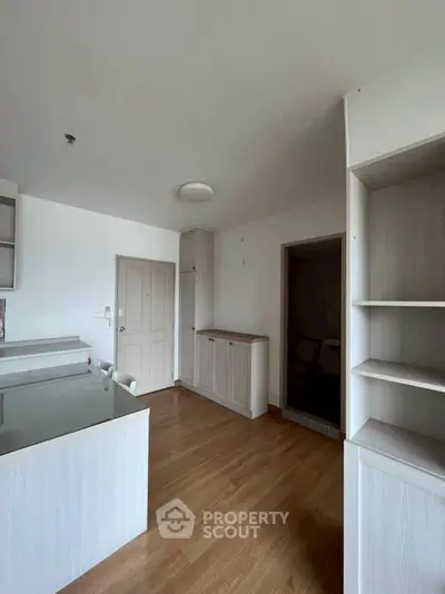 Spacious modern kitchen with wooden flooring and ample storage space