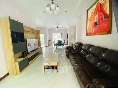 Spacious living room with modern decor and leather sofa