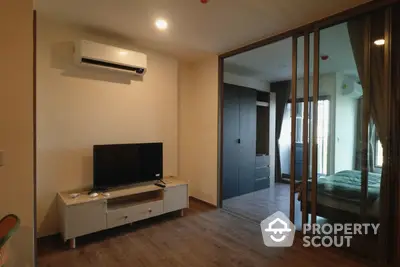 Modern apartment interior with sleek design and open layout, featuring a cozy living area and stylish bedroom.