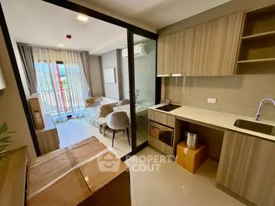 Modern open-layout living room and kitchen with balcony view
