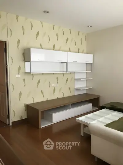 Modern living room with stylish wall shelves and cozy seating area.