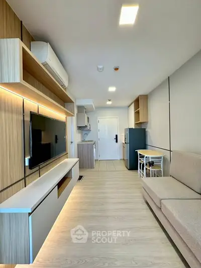 Modern living room with sleek design, featuring built-in TV unit and cozy seating area.