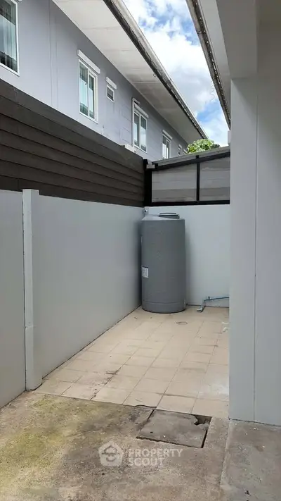 Outdoor utility area with water tank in modern residential building