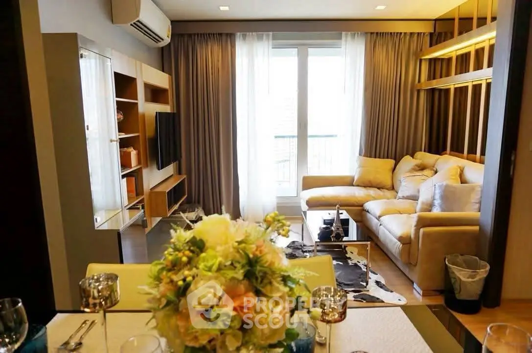 Luxurious living room with elegant decor and large windows offering natural light.