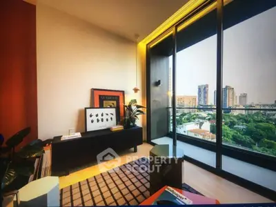 Modern living room with large windows offering stunning city views, stylish decor, and abundant natural light.