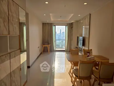 Modern living room with city view, elegant dining set, and sleek TV setup in a high-rise apartment.